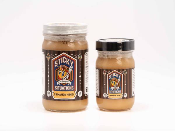 8 oz sticky situations cinnamon honey on left with 4 oz jar on right
