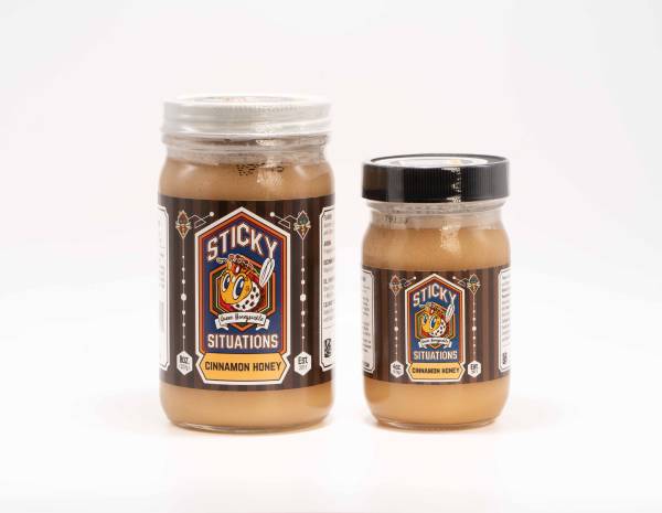 8 oz sticky situations cinnamon honey on left with 4 oz jar on right