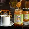 8 oz lavender honey at center, 4 oz lavender honey jar at right, and a cup of tea on left