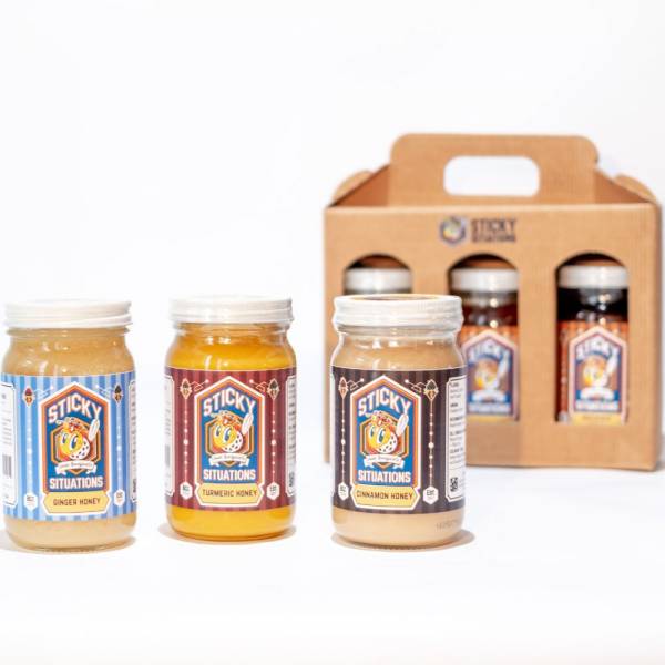 sticky situations ginger, turmeric, and lemon honey with a 3-pack honey box in background.