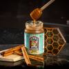 cinnamon honey butter with honey dipper going into top and cinnamon sticks on left