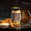 8 oz jar of sticky situations cinnamon honey with cinnamon sticks to left